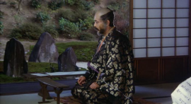 Shingen stares at a cool kidney-shaped armrest thing.